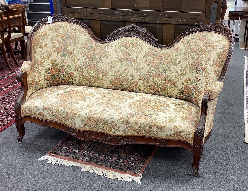 A Victorian upholstered carved mahogany double spoonback settee, width 176cm, depth 74cm, height 99cm
